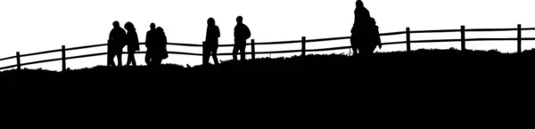 フェンスの前を歩いている人々のシルエット — ストックベクタ