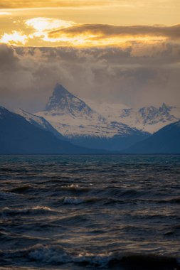 Gölün üzerinde güzel bir gün batımı ve Patagonya 'nın arka planında karlı dağ Arjantin' de