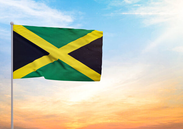 3D illustration of a Jamaica flag extended on a flagpole and in the background a beautiful sky with a sunset