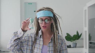 Hoş bir milenyum hipster beyaz kadın modaya uygun afro rasta saçı olan, elinde yeşil renkli ekranlı akıllı bir telefon tutan, boş boş ekranı işaret eden reklam metninin kopyası ile