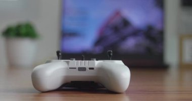 Yakın plan bir fpv joystick odak noktası iş yerindeki bulanık arkaplan üzerinde bir konsol yatar.