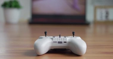 Close-up lies on the table joystick to control fpv drone. Joystick for control in the simulator The concept of flying a drone. Joystick for control in a bright room on a wooden table