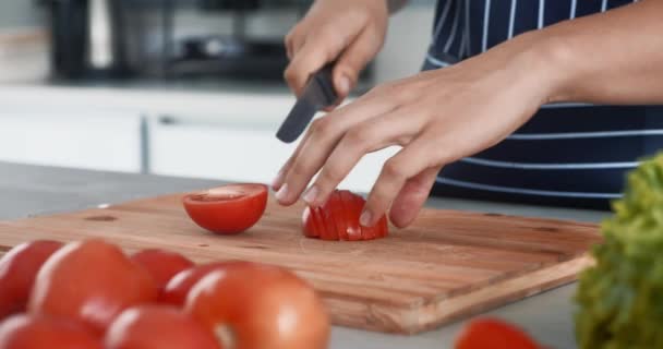 女的手在厨房切西红柿 特写镜头手在木板上切下红色西红柿 作为沙拉健康食品 健康食品概念切碎了现代厨房公寓背景的西红柿 — 图库视频影像