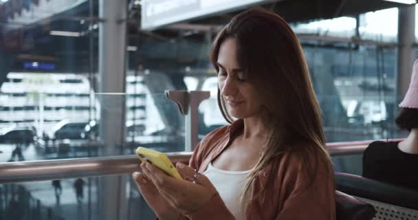 Woman Waiting Flight Sitting Airport Terminal Uses Smartphone Browse Internet — Stock Video