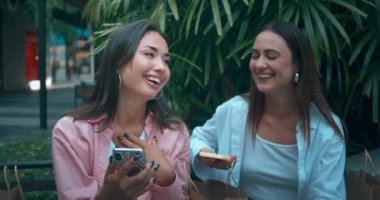 Kız kardeşler mutluluk gösteren telefonları paylaşıyorlar. Mutluluk, dostluk, gülümseme, kahkaha, saygı, dostluk, dostluk, yakınlaşma, yakınlaşma.