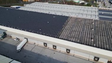 Endüstriyel binalardaki güneş panellerinin hava görüntüsü. İnsansız hava aracı bakış açısı, sanayi bölgesinde uçmak, çatıları güneş panelleriyle kaplı..