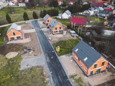Drone view, aerial shoot of new build houses in the suburbs of Slovenia, somewhere in the country side, Europe. New modern houses, family homes.
