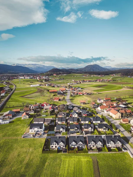Drone view, aerial shoot of new build houses in the suburbs of Slovenia, somewhere in the country side, Europe. New modern houses, family homes.