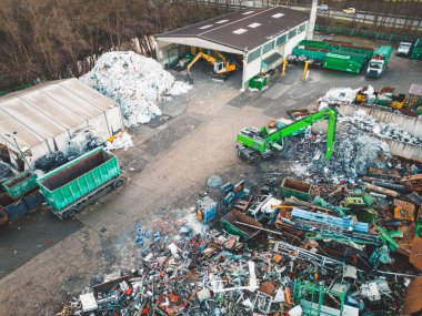 Aerial view, drone shoot of recycling center, containers for sorting out different garbage materials. Excess garbage problems. Reduce, reuse, recycle. 