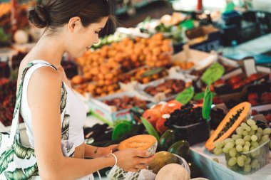 Young caucasian woman doing errands around the city, shopping at the market, going for lunch, walking around the city and enjoying a beautiful sunny day. 