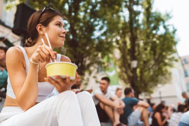 Young caucasian woman doing errands around the city, shopping at the market, going for lunch, walking around the city and enjoying a beautiful sunny day. 