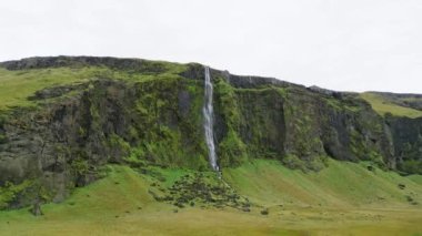 Iceland waterfall nature travel landscape in Icelandic nature background. Popular tourist attraction summer holiday destination in on South Iceland. High quality video