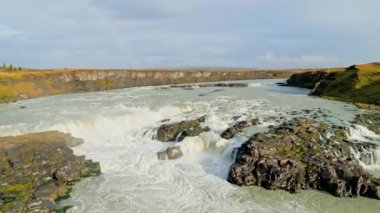 Bright blue river trough Iceland mainland in autumn time on a cold day. High quality video