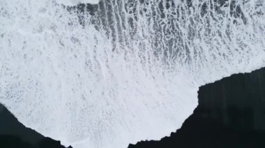 Top down view of waves crashing on the black sands beaches of Selheimasandur in Southern Iceland. High quality video