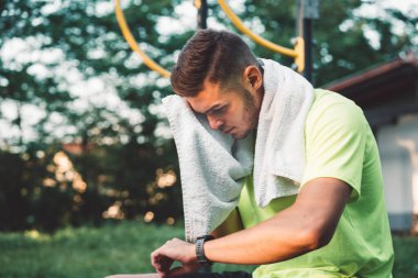Fit man checking smart watch wearable technology sport smartwatch on workout outside. Man wearing smart watch during his training, measuring his activity. High quality photo