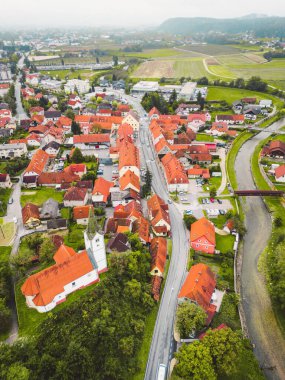 Drone stills of a small town in the countryside in autumn. River running trough the town, aerial view. 