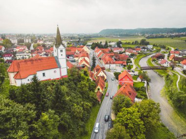 Drone stills of a small town in the countryside in autumn. River running trough the town, aerial view. 