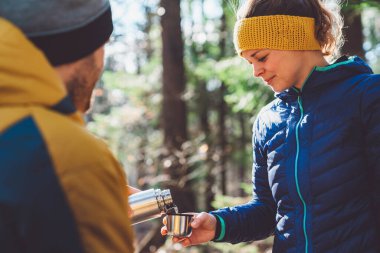 Hikers getting ready at the trunk of the car. Adventurous people, mountaineers getting ready for a hike at the car. 