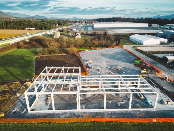 Warehouse Construction from metal structure. Industrial building on light gauge steel framing. Frame of modern hangar or factory. Construction site with steel structure warehouse. Top view on a roof
