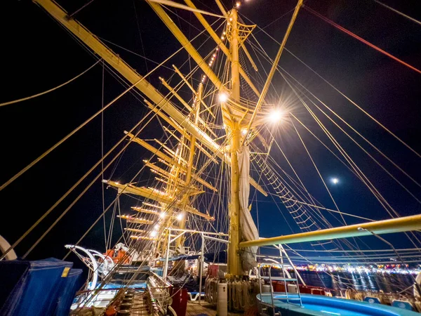 On board a large sailing ship at night.