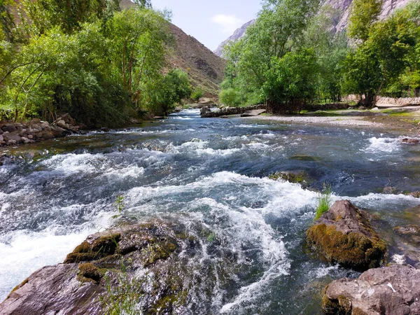 stock image The small river at Haftkul in Tajikistan is very fast.