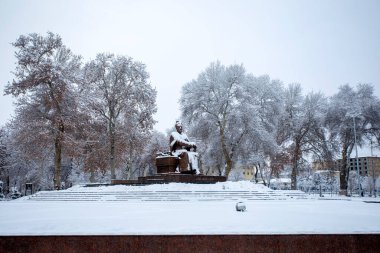 The statue of Amir Temur on his throne in Samarkand by the snow. 2 clipart