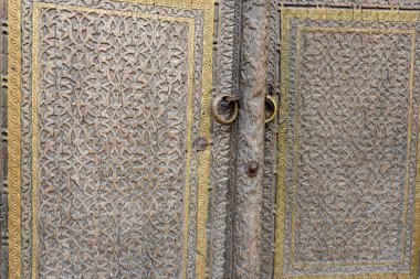 Kapı kolunda yüzük olan tahta bir kapı.