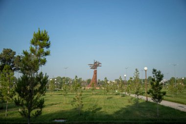 a statue in a park of uzbekistan clipart