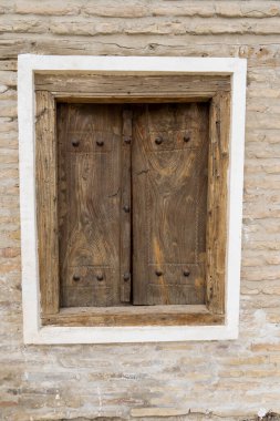 a closed wooden door in a historical place in uzbekistan clipart