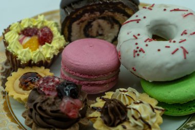 group of cakes and biscuits in a plate with a white background