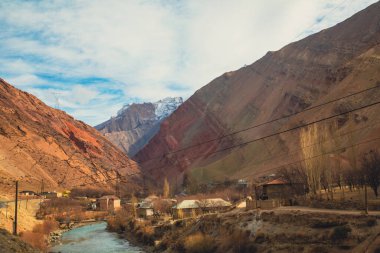 the river flow in a town city with a bridge connecting each other town in Tajikistan clipart