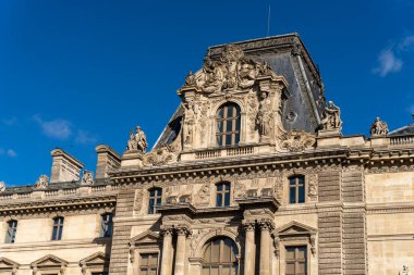 Binanın bir sürü penceresi ve çok süslü bir tasarımı var.