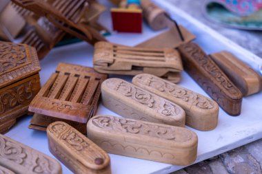 Üzerinde karmaşık oymalar olan ahşap kutu koleksiyonu. Kutular beyaz bir yüzeye yerleştirildi.