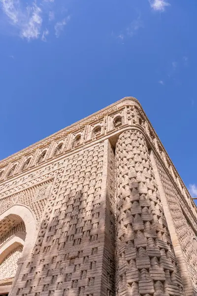 Binanın çok fazla detayı var ve çok uzun. Güneş onun üzerinde parlıyor, güzel bir gölge oluşturuyor.