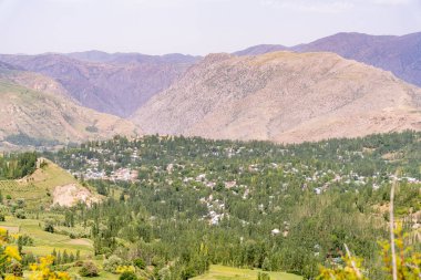 Vadide küçük bir kasabası olan bir dağ sırası. Kasaba ağaçlar ve evlerle çevrili.