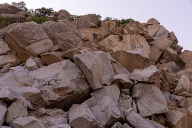 Kayalıklarda grafiti olan kayalık bir yamaç. Grafitide 