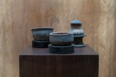 Chennai, Tamil Nadu, Hindistan - 02.07.2025: Tahta bir kaidede üç seramik kase bulunuyor. Kaseler farklı boyutlarda ve şekillerde. Chennai 'de.