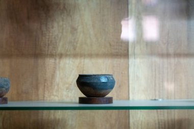 Chennai, Tamil Nadu, Hindistan - 02.07.2025: Küçük mavi bir kase ahşap bir rafta duruyor. Rafta ahşaptan yapılmış ve cam bir kapağı var. Chennai 'de.