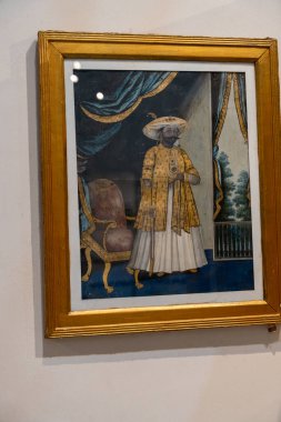 Chennai, Tamil Nadu, Hindistan - 02.07.2025: Sarı cüppeli bir adam bir sandalyenin önünde duruyor. Sandalye arka planda. Chennai 'de.