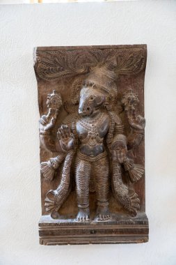 Chennai, Tamil Nadu, Hindistan - 02.07.2025: Kafasında kuş olan bir kişinin heykeli. Heykel ahşaptan yapılmıştır ve kahverengi renktedir. Chennai 'de.