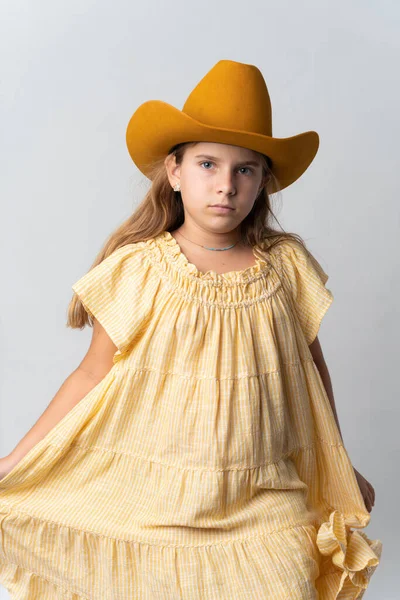 stock image Stylish young girl in yellow dress and orang hat. High quality photo