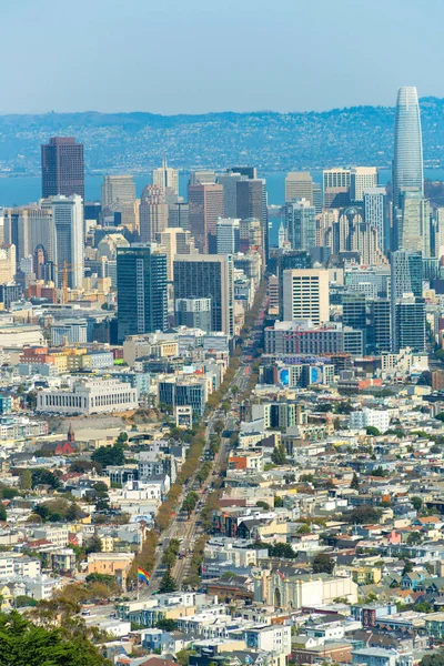 peaceful downtown san francisco withsuburban outskirs in city with mian road and tall sky scrapers and moutains and ocean background on blue and white sky