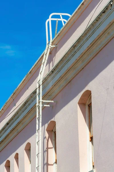 Růžová Budova Kovovou Střechou Přístup Žebřík Modré Obloze Mraky Pozadí — Stock fotografie