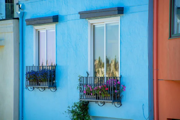 Row Black Balconies Blue Stucco House Exterior Red Door Visible — Stock Photo, Image