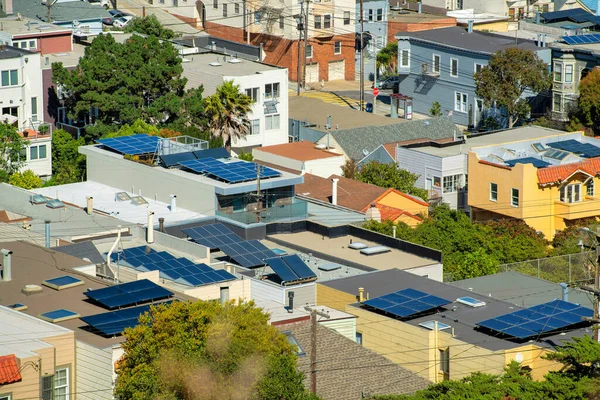 Many rooftops with solar pannels and flat roofs in the historic districts of downtown san francisco california. Clean energy in the city to combat climate change and global warming in neighborhood.