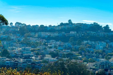 Modern cityscape with tons of houses and homes in downtown city with buildings and businesses. Clear blue sky with clouds in the historic districts of downtown San Francisco California.