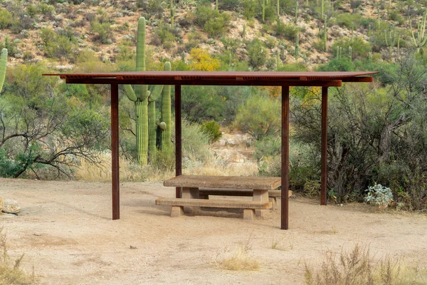 Park and outdoor awning in sabino national area in tuscon arizona with metal gazebo and cement bench for picnics. Late in the day in outdoor realm for hiking and jogging and traveling adventures.