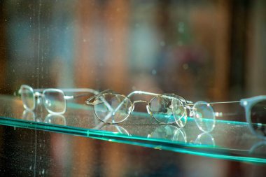 Şehrin kentsel alanındaki optometri optomestrist ofisi için iş kurumunda cam rafta reçeteli gözlük. Daha iyi görmek ve tıbbi nedenlerden dolayı görme için muayeneler.