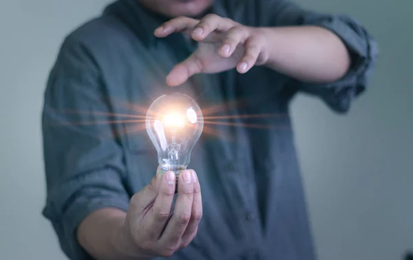 human hand with light bulb An idea inspired by online technology. innovation concept