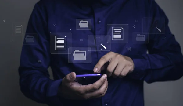 Document management system concept, business man holding folder and document icon software, searching and managing files online document database, for efficient archiving and company data.